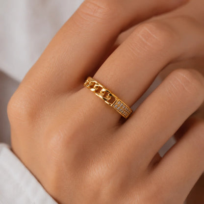 Primer plano de la mano con el anillo de cadena cubana y su banda en pavé