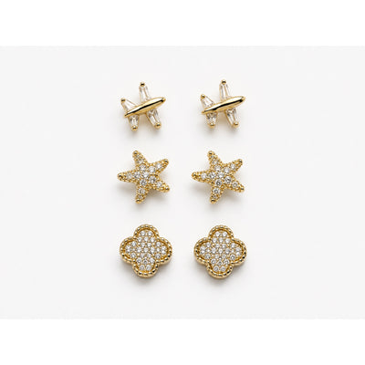 Set de tres pares de aretes dorados en pavé con forma de avión, estrella y trébol