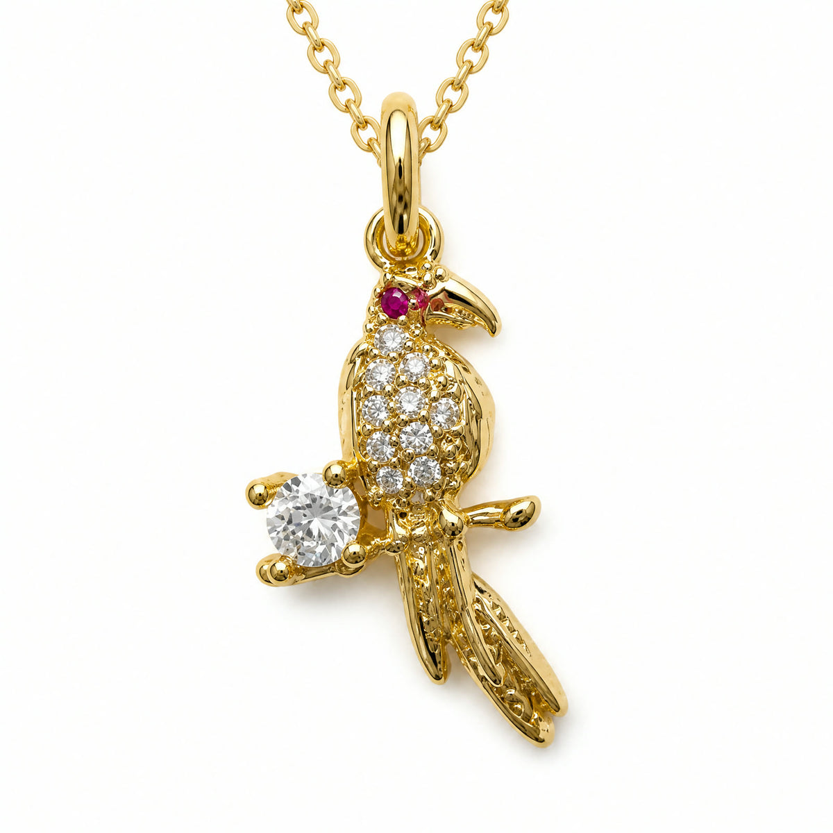Dije dorado de loro en pave posado en una rama