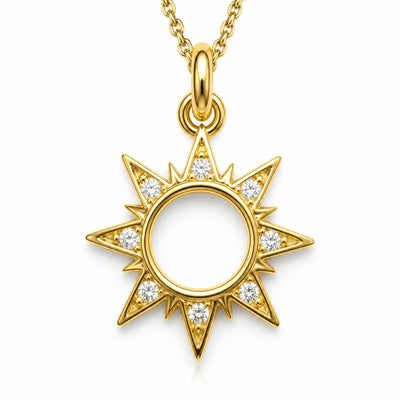 Dije dorado de sol con rayos y contorno en pave