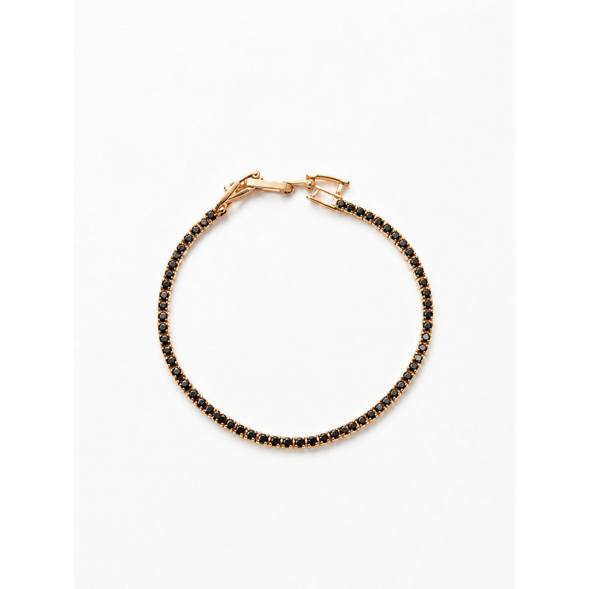Pulsera tenis dorada con piedras negras en toda la vuelta