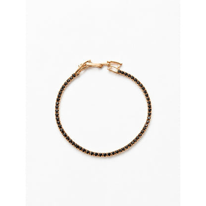 Pulsera tenis dorada con piedras negras en toda la vuelta